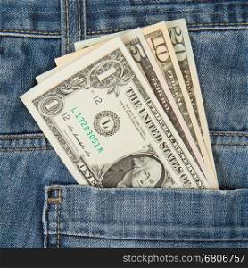 Macro shot of trendy jeans with american four different dollar bills on its pocket