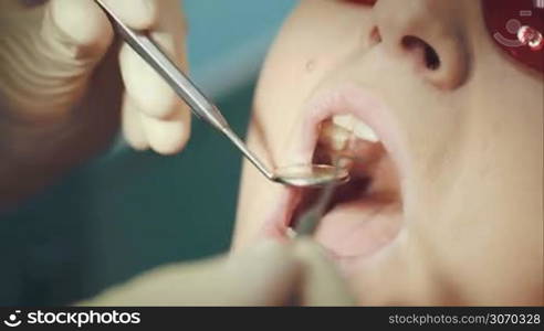 Macro shot of woman in safety glasses going through the dental examination
