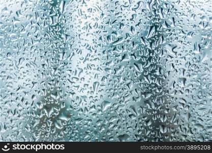 Macro texture of glass covered by water drops at rainy day