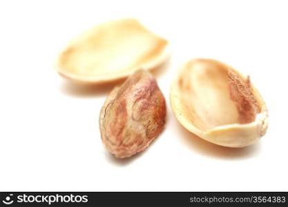macro toasted pistachios on a white background