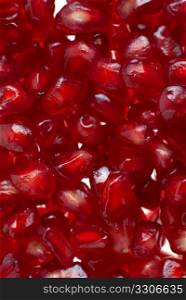 Macro up view of peeled red ripe pomegranate seeds.