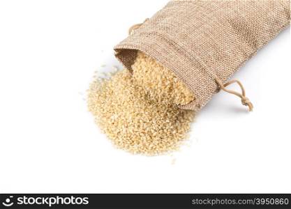 Macro view of sesame seeds in flax sack with tie isolated on white background
