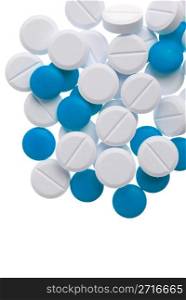 Macro view of white and blue pills on blue background.