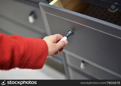 Macro woman opening a cabinet