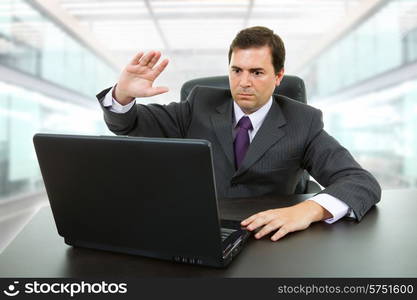 mad business man working with is laptop, at the office
