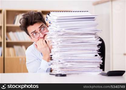 Mad businessman with piles of papers
