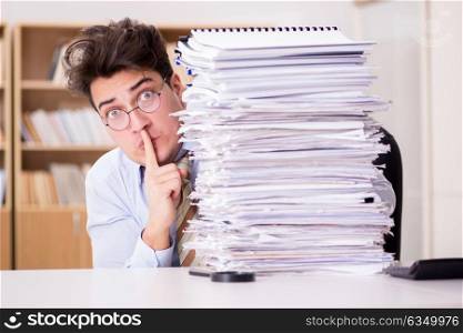 Mad businessman with piles of papers