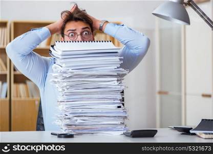 Mad businessman with piles of papers. The mad businessman with piles of papers