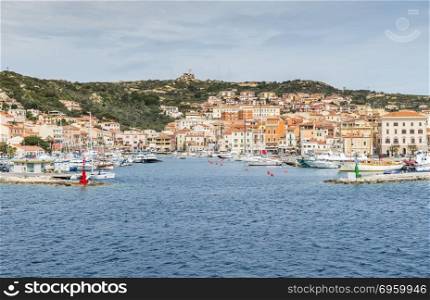 Maddalena,Italy,07-april-2018:La Maddalena village seen from the water in La Maddalena island, Sardinia, Italy, you arrive this island with the ferry from Palua on the italien island of sardinia. La Maddalena village in La Maddalena island, Sardinia, Italy. La Maddalena village in La Maddalena island, Sardinia, Italy