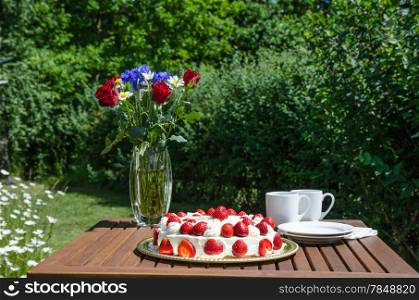 Made and decorated table for a cup of coffee in the garden at summer