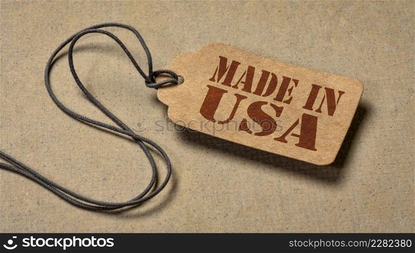 made in USA sign - red stencil text on a paper price tag against textured paper