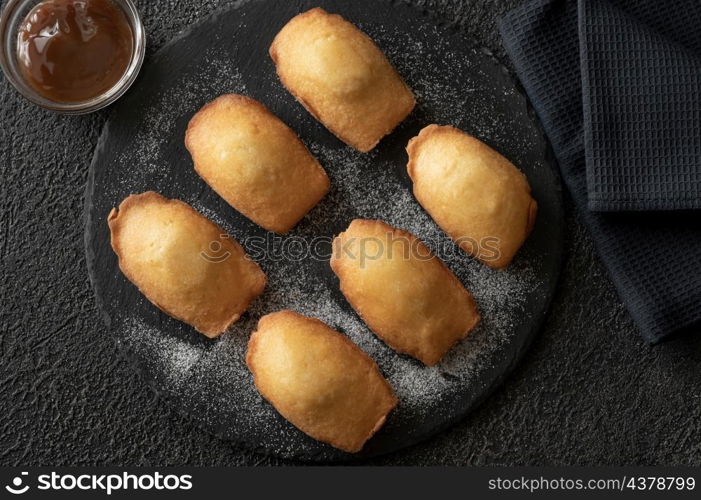 Madeleines - French small sponge cakes on the stone board