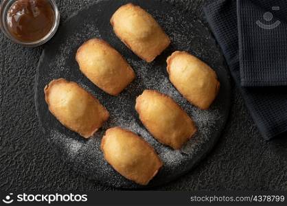 Madeleines - French small sponge cakes on the stone board