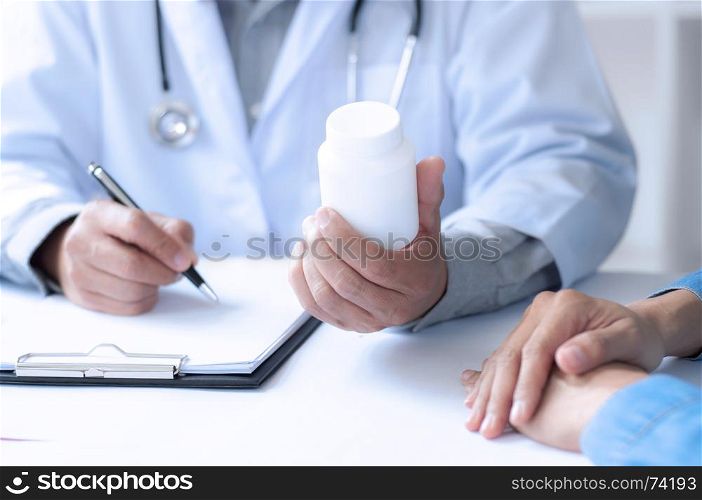 madicine doctor giving pills to patient at a hospital / clinic