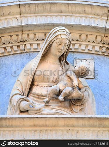 Madonna and Child carving on the church of Santa Maria dia Miracoli in Venice, Italy. banding in the stone gives the impression that the Madonna is weeping