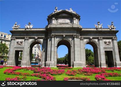 Madrid Puerta de Alcala with flower gardens in Spain