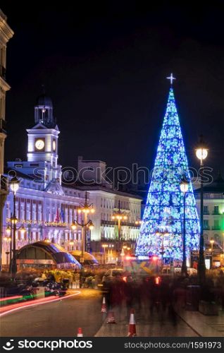 MADRID, SPAIN - JANUARY 4, 2020: Crowds of people gather at the Puerta del Sol square in Madrid, Spain, with the traditional illuminated Christmas tree rising in its center.