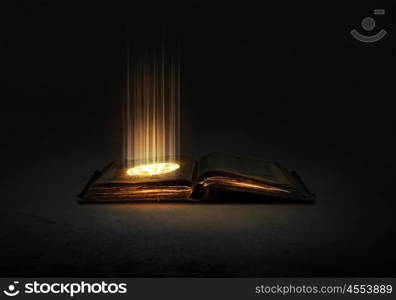 Magic book. Old black magic book with lights on pages