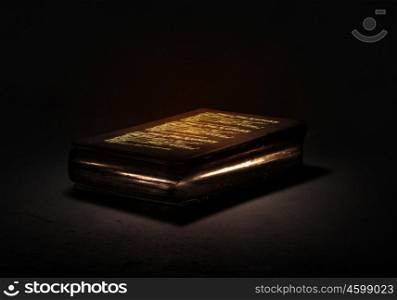 Magic book. Old black magic book with lights on pages