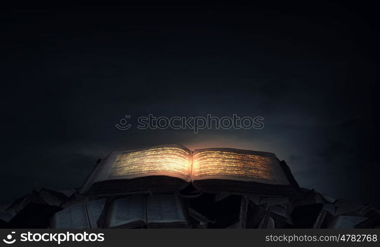 Magic book. Old black magic book with lights on pages