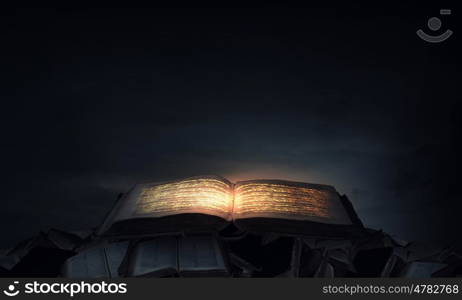 Magic book. Old black magic book with lights on pages