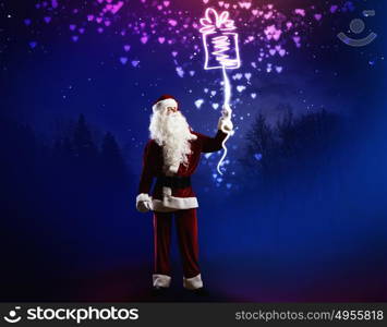 Magic Christmas eve. Santa Clause in red costume against blue background