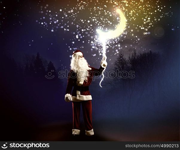 Magic Christmas eve. Santa Clause in red costume against blue background