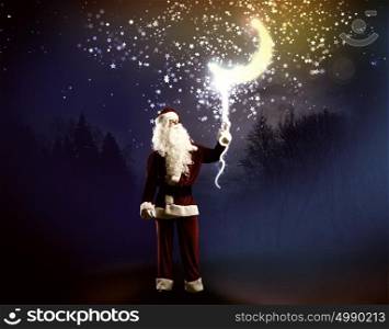Magic Christmas eve. Santa Clause in red costume against blue background