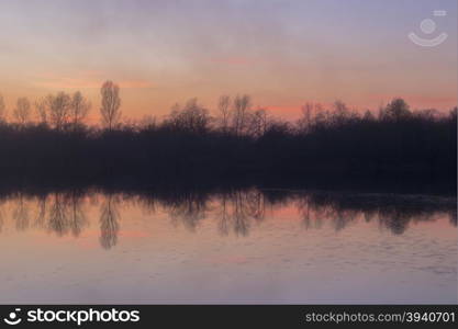 magic mist over the river and the forest at sunset