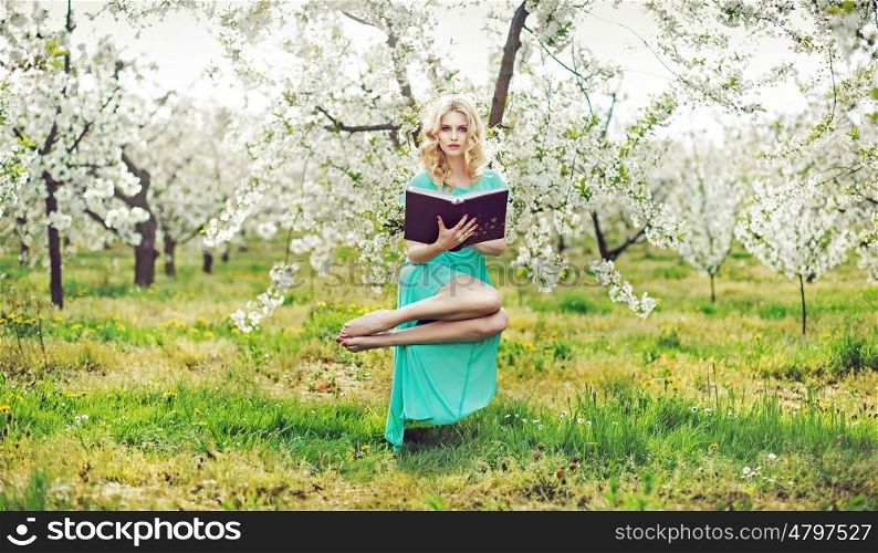 Magic nymph holding a book and levitating