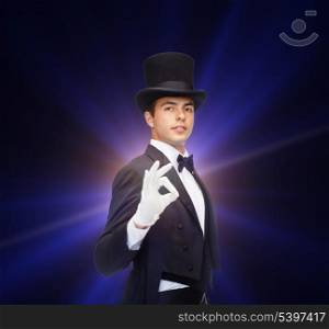 magic, performance, circus, show concept - magician in top hat showing trick