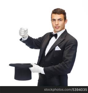 magic, performance, circus, show concept - magician in top hat showing trick with imaginary rabbit