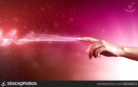 magical hand conceptual image with sparkles on colour background