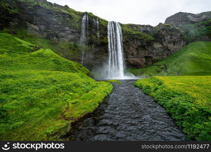 Magical Seljalandsfoss Waterfall in Iceland. It is located near ring road of South Iceland. Majestic and picturesque, it is one of the most photographed breathtaking place of Iceland.