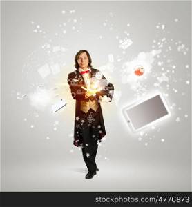 Magician and computer devices. Image of magician with hat and computer devices flying in air