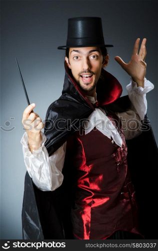 Magician doing tricks in dark room