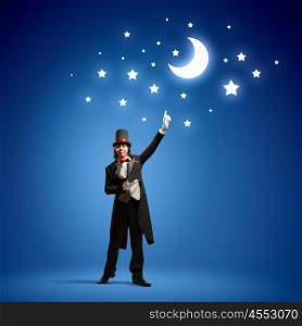 Magician in hat. Image of man magician against color background