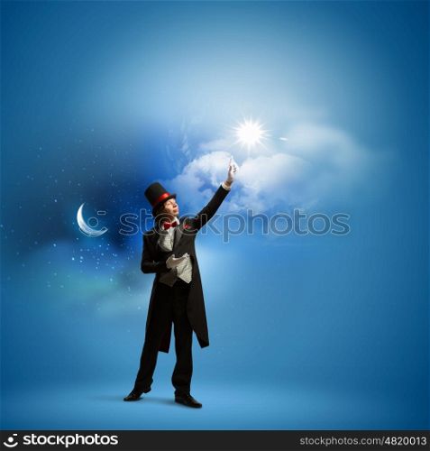 Magician in hat. Image of man magician against color background