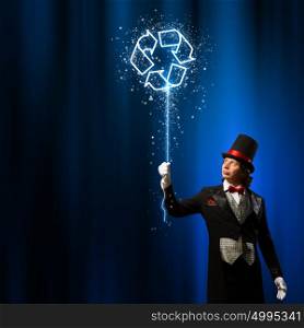 Magician in hat. Image of man magician against color background. Recycle concept
