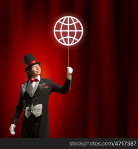 Magician in hat. Image of man magician with balloon against color background
