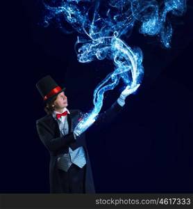 Magician in hat. Image of wizard in red bow tie showing tricks