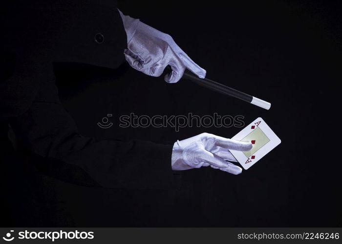 magician performing trick aces playing card against black background