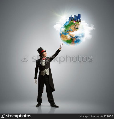 Magician with globe. Image of magician in hat holding globe. Ecology concept. Elements of this image are furnished by NASA