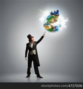 Magician with globe. Image of magician in hat holding globe. Ecology concept. Elements of this image are furnished by NASA