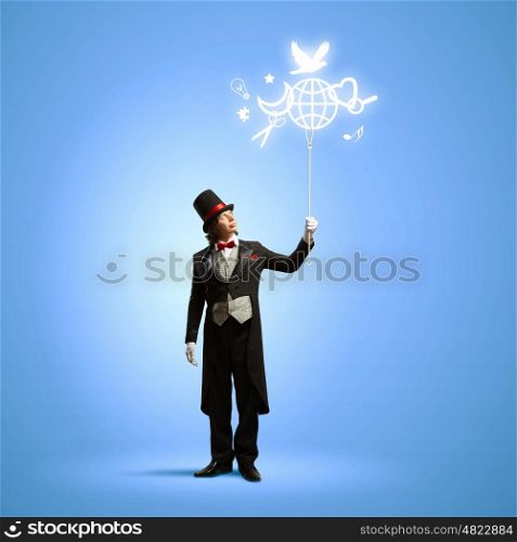 Magician with globe. Image of magician in hat holding globe. Ecology concept