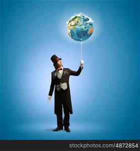 Magician with globe. Image of magician in hat holding globe. Ecology concept. Elements of this image are furnished by NASA