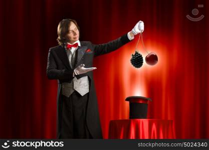 Magician with hat. Image of magician showing tricks with hat