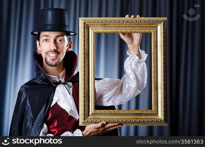 Magician with photoframe in studio