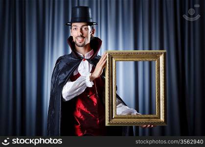 Magician with photoframe in studio