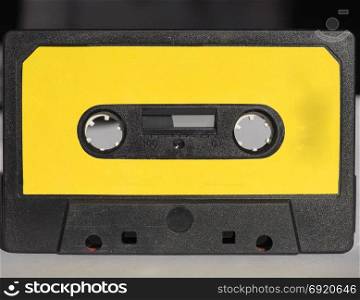 magnetic tape cassette. black magnetic tape cassette for analog audio music recording with yellow label